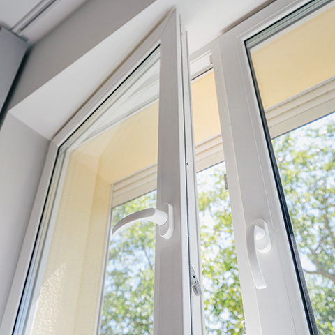modern window with handle partially opened showcasing clear glass and view of trees outside enhancing 19th century architecture