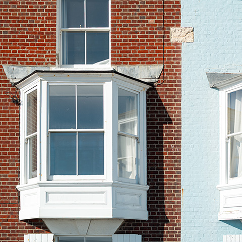 bay window design on brick and blue wall showing architectural features and ten stunning elements